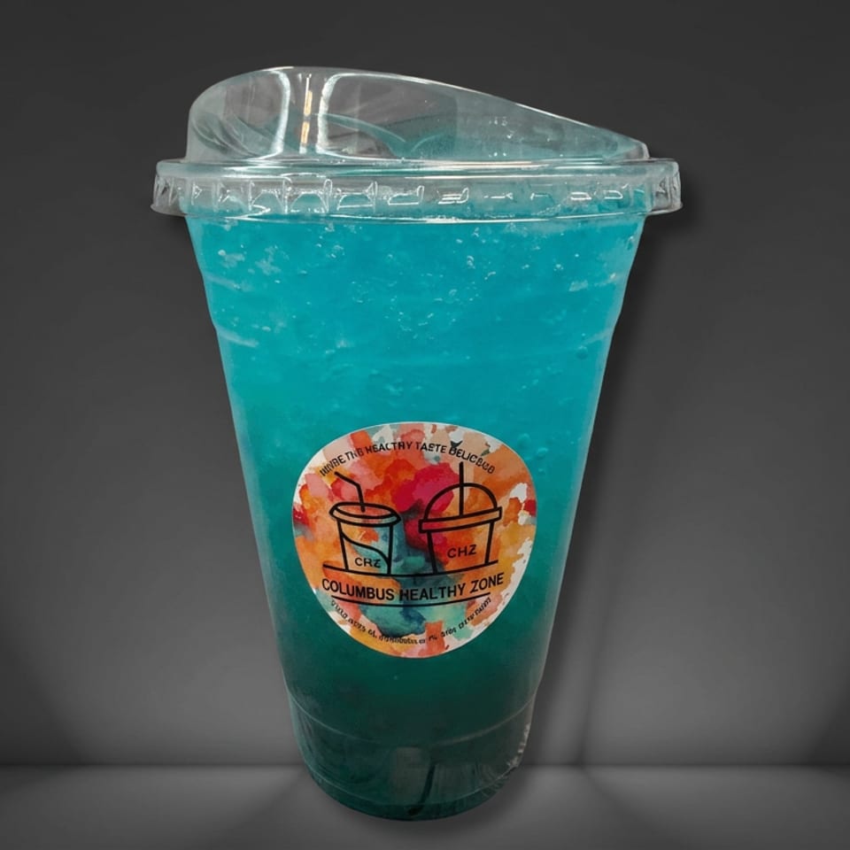Bright blue frozen beverage in a clear lidded cup labeled Columbus Healthy Zone against a dark background.